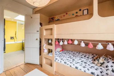 a childs bedroom with a bunk bed with stuffed animals at The Limes, Benhall in Saxmundham