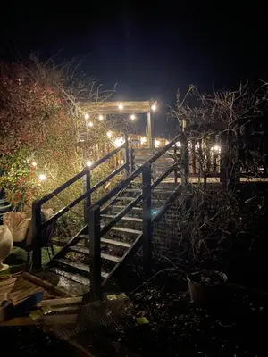 a set of stairs at night with lights at Spacious Cabin with Private Hot Tub, and Private Pool, in 5 Acres - intimate Special stay For 2 Adults - plus 1 child under 2 and up to 2 dogs stay for free in Downham