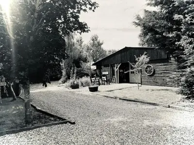 a black and white photo of a log cabin at Spacious Cabin with Private Hot Tub, and Private Pool, in 5 Acres - intimate Special stay For 2 Adults - plus 1 child under 2 and up to 2 dogs stay for free in Downham