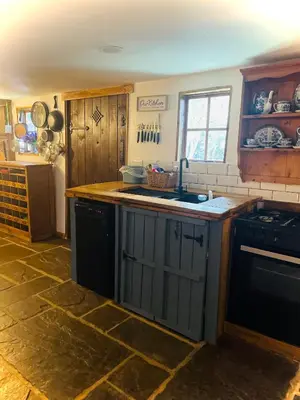a kitchen with a sink and a stove at Spacious Cabin with Private Hot Tub, and Private Pool, in 5 Acres - intimate Special stay For 2 Adults - plus 1 child under 2 and up to 2 dogs stay for free in Downham