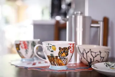 a table with three coffee cups on a table at Georgina in Lavenham
