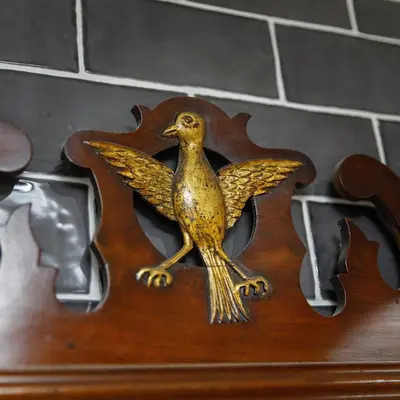 a bronze bird statuation on a wooden object at Georgina in Lavenham
