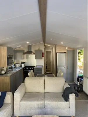 a living room with a couch and a kitchen at KellysHolidayHomes 26 Willerby 2 bedrooms caravan in Weeley
