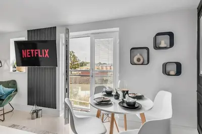 a white dining room with a white table and chairs at Modern Apartment in Wymondham in Wymondham