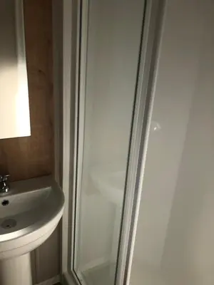 a bathroom with a shower and a sink at Modern 3 bedroom caravan near the beach in Walton-on-the-Naze