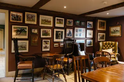 a restaurant with pictures on the wall at The Crown, Bildeston in Bildeston