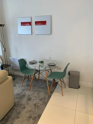 a dining room with a table and two chairs at The office at the old Forge in Great Wymondley