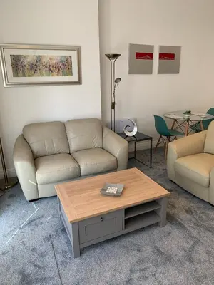 a living room with two couches and a coffee table at The office at the old Forge in Great Wymondley