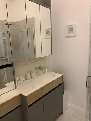 a bathroom with a sink and a mirror at The office at the old Forge in Great Wymondley