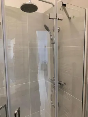 a shower with a glass door in a bathroom at The office at the old Forge in Great Wymondley