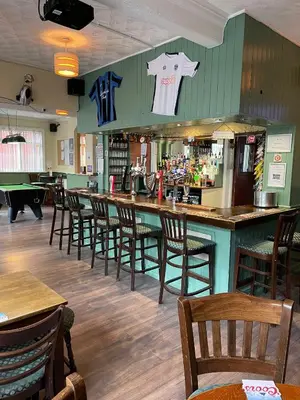 a bar with a bunch of chairs in a restaurant at Shakers Inn in Harwich