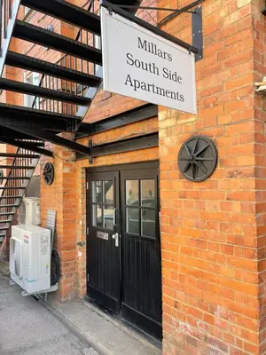 a sign on the side of a brick building at Fantastic convenient 2 Bedroom 2 bathroom Perfect for Stansted Airport, 3 minute walk to Bishops Stortford Train Station! in Bishops Stortford