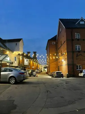 a city street with cars parked in front of buildings at Fantastic convenient 2 Bedroom 2 bathroom Perfect for Stansted Airport, 3 minute walk to Bishops Stortford Train Station! in Bishops Stortford