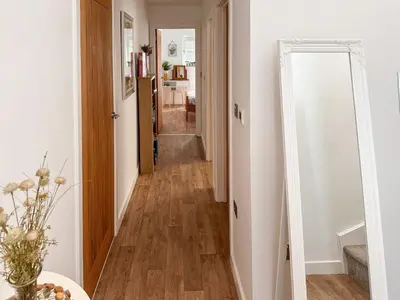 a hallway with a mirror next to a room at Secretseaview in West Mersea