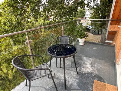 a table and two chairs on a balcony at Secretseaview in West Mersea