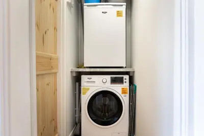 a washer and dryer in a room with a wall at Mill Dam Lake House in Saint Osyth