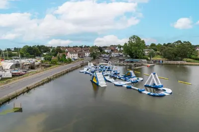a group of boats are docked in a river at Mill Dam Lake House in Saint Osyth