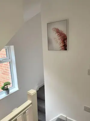 a staircase in a house with a picture on the wall at Cambridge Studios and Suites by Tas Accommodations in Cambridge
