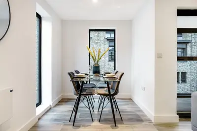a dining room with a glass table and chairs at Tailored Stays - Central Cambridge, Lacon House in Cambridge