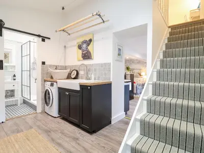 a kitchen and laundry room with a washer and dryer at Tower End Cottage in Woodbridge