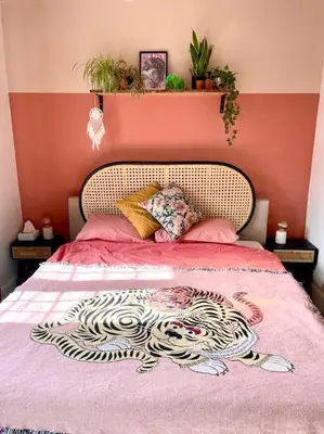 a bedroom with a bed with a pink wall at 3 Bedroom Spacious Seaside Apartment with Estuary Views in Southend-on-Sea