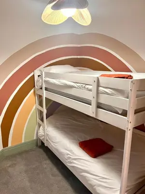 a bunk bed with a rainbow painted on the wall at 3 Bedroom Spacious Seaside Apartment with Estuary Views in Southend-on-Sea