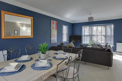 a living room with a table and a couch at Elizabeth Townhouse Braintree in Bocking Churchstreet