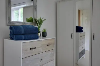 a dressing room with a mirror and a dresser at Elizabeth Townhouse Braintree in Bocking Churchstreet