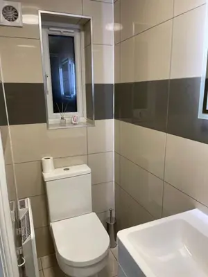 a bathroom with a white toilet and a sink at Modern 1 Bedroom Holiday Apartment in Southminster in Southminster