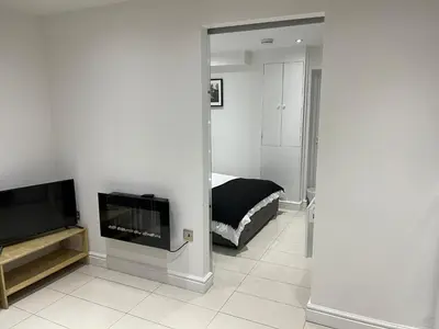 a bedroom with a bed and a television in a room at Modern 1 Bedroom Holiday Apartment in Southminster in Southminster