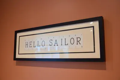 a framed picture of a hello salon sign on a wall at 11 Crabbe Street, Aldeburgh in Aldeburgh