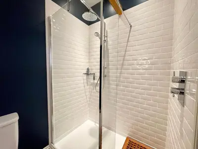a shower with a glass door in a bathroom at 11 Crabbe Street, Aldeburgh in Aldeburgh