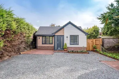 a small white house with a driveway at 4 Eureka Waldringfield in Woodbridge