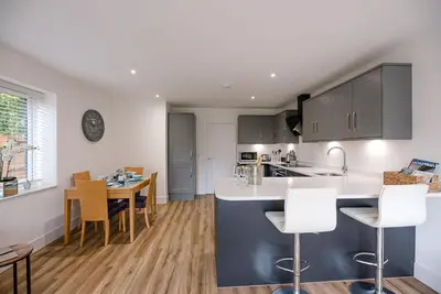 a kitchen and dining room with a table and chairs at 4 Eureka Waldringfield in Woodbridge