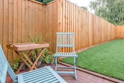 a desk and a chair and a table and a fence at 4 Eureka Waldringfield in Woodbridge