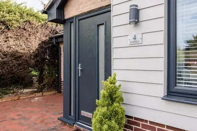 a black door on a house with a christmas tree at 4 Eureka Waldringfield in Woodbridge