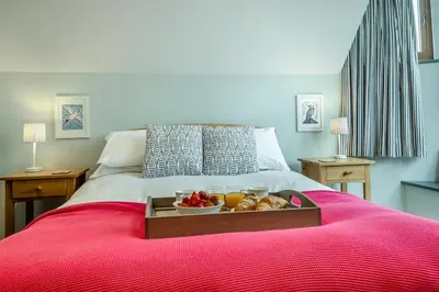 a tray with a bowl of fruit on a bed at 3 Bed in Aldeburgh oc-16afaw in Aldeburgh