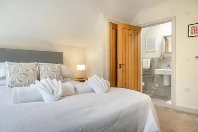 a bedroom with a white bed and a bathroom at 3 Bed in Aldeburgh oc-16afaw in Aldeburgh