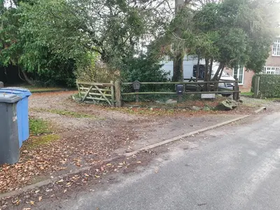 a wooden fence on the side of a road at Cosy Rural Barn Conversion 5 Min Drive To Pin Mill 1 BR + sofa bed in Chelmondiston