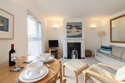 a living room with a table and a couch at The Bolthole in Aldeburgh