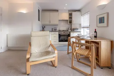 a kitchen with a table and chairs and a dining room at The Bolthole in Aldeburgh