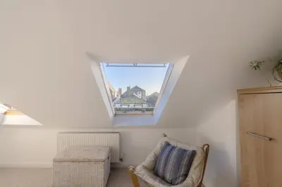 a room with a chair and a window at The Bolthole in Aldeburgh