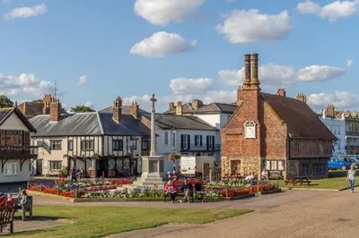 a group of people walking around a town with buildings at The Bolthole in Aldeburgh