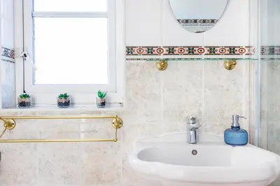 a bathroom with a sink and a window at 6 Bedroom Larger group House with Parking Corringham Stanford Le Hope in Horndon on the Hill