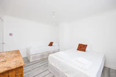 a room with two beds and a table at 6 Bedroom Larger group House with Parking Corringham Stanford Le Hope in Horndon on the Hill