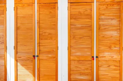 two wooden doors on the side of a building at 6 Bedroom Larger group House with Parking Corringham Stanford Le Hope in Horndon on the Hill