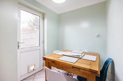 an office with a wooden table and chairs and a door at 6 Bedroom Larger group House with Parking Corringham Stanford Le Hope in Horndon on the Hill