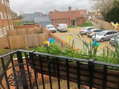 a balcony with cars parked in a parking lot at 4 Ropers Court, Lavenham in Lavenham