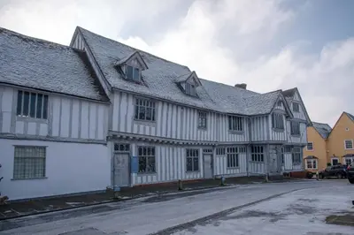 a large white building with windows on a street at 4 Ropers Court, Lavenham in Lavenham