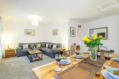 a living room with a couch and a table at 1 King Street in Aldeburgh